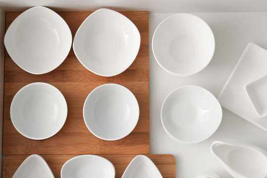Set of ceramic tableware in kitchen drawer