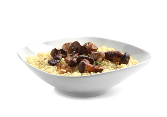 Plate with tasty risotto and mushrooms on white background