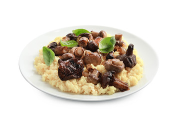 Plate with tasty risotto and mushrooms on white background