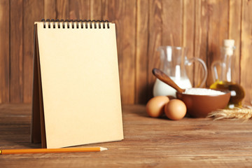 Notebook on kitchen table. Making homemade bread