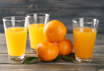Fresh citrus juice in glasses on table