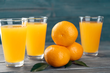 Fresh citrus juice in glasses on table