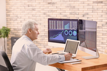 Male broker working in office. Finance trading concept