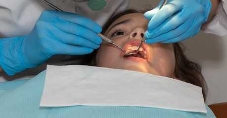 Fototapeta premium background. professional dental treatment for girls. examination and treatment by a dentist