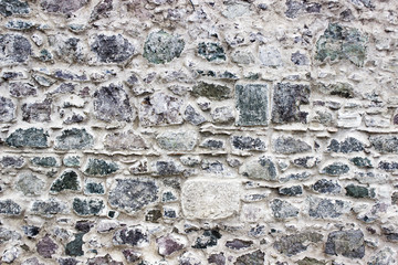 front wide shot of highlighted masonry colorful stone wall in Izmir at Turkey with traditional stucco