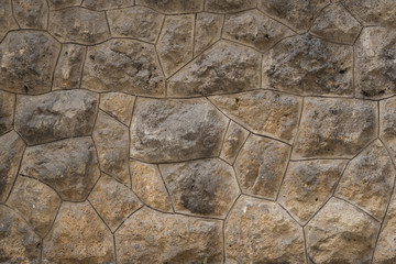 Old stone wall as texture or background. Old exterior wall with big rocks.