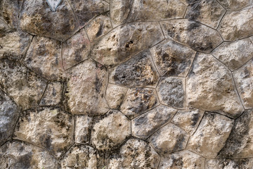 Old stone wall as texture or background. Old exterior wall with big rocks.