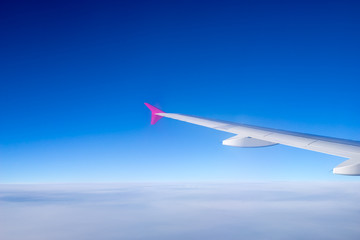 Wing of the plane on blue sky background