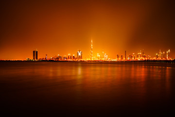 Skyline of Dubai city illuminated in orange 