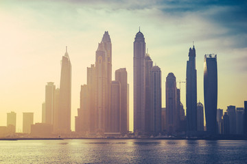 Obraz premium Vintage sunrise view of Dubai marina with noise and grain effect 
