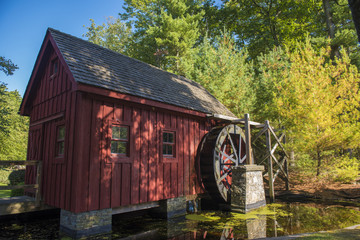 An Old Wooden Water Mill by a Pond