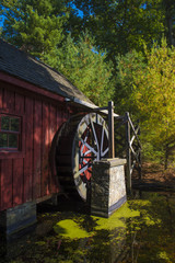 An Old Wooden Water Mill by a Pond
