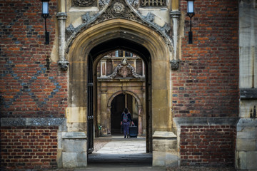 Student walking through the gate in Cambridge