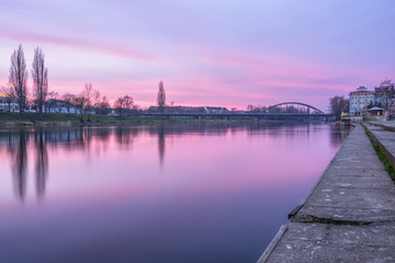 Fototapeta na wymiar View of Warta river and railway bridge at sunrise in Gorzow, Poland 