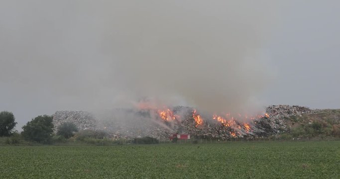 Firefighters at Garbage Dump With Heavy Smoke Pollution Landfill Fire