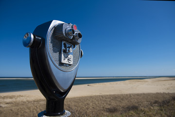 Binoculars by the Chatham Lighthouse Beach with ocean view as a backdrop.