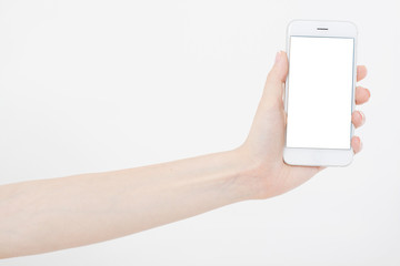 Hand holding white cellphone isolated on white clipping path inside. Online shopping. Top view....