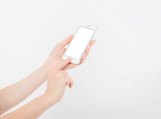 Hand holding white cellphone isolated on white clipping path inside. Online shopping. Top view....