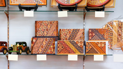 Wooden handmade crafts on the shelf in the store