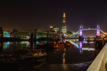 Fototapeta na wymiar Famous Tower Bridge at night with light reflections, London, England