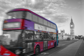 Fototapeta na wymiar Abstract view of red double decker bus in motion with Big Ben in the background
