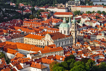 Fototapeta na wymiar Aerial view of the city. St. Nicolas churc over old town red roofs. Prague, Czech Republic