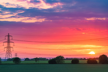 Fototapeta premium Electric transmission tower at sunset