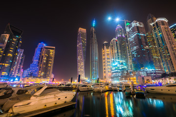 Dubai marina at night viewed from boat pier, UAE