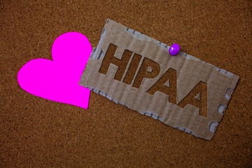 Conceptual hand writing showing Hipaa. Business photo text Health Insurance Portability and Accountability Act Healthcare Law Brown old damaged paperboard ideas pink heart cork background.