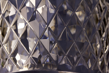 Macro abstract of diamond cut facets on beautiful lead crystal glass reflecting natural light