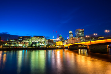 Fototapeta na wymiar London bridge and Financial District of London at dusk