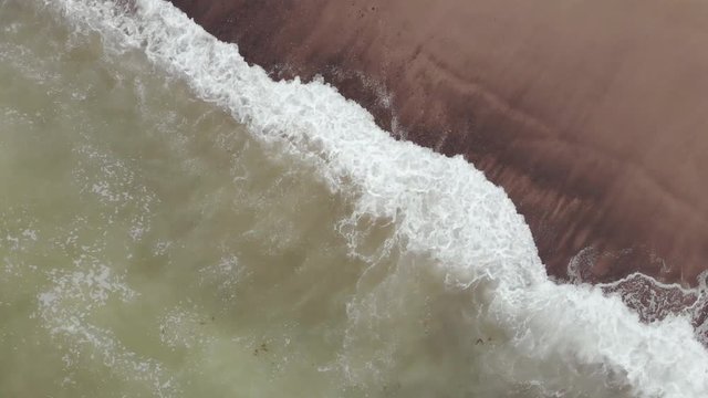 Waves breaking on cobblestone shoreline