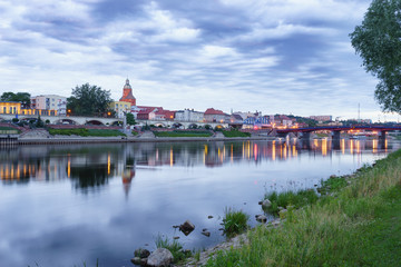 Obraz premium Evening panorama of Warta river,Old Town bridge and boulevard in Gorzow Wielkopolski, Poland