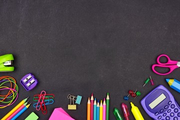 School supplies bottom border on a chalkboard background with copy space