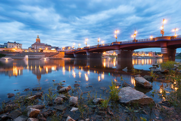 Gorzow city skyline at dusk including old town bridge and tower of St. Mary's cathedral. Poland