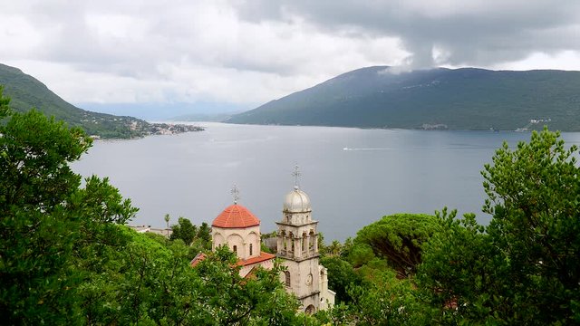 Dormition Church of Savina Orthodox monastery in Herceg Novi coastal town at the entrance to Kotor Bay in Montenegro. Timelapse.