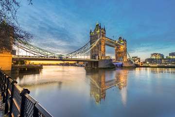 Fototapeta na wymiar Tower bridge at sunrise with reflection in London,England