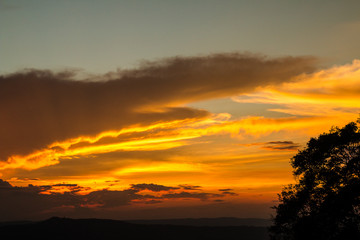 Fototapeta na wymiar Gold evening after sunset. The clouds reflect light beautifully