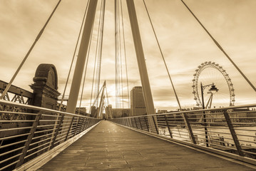 Vintage picture of Jubilee Bridge at sunrise in London, England.