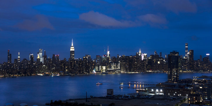JUNE 3, 2018 - NEW YORK, NEW YORK, USA  - New York City and East River shows Chrysler Building on right and Empire State Building on Left, as seen from Queens