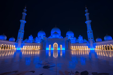 Entrance to Sheikh Zayed Grand mosque viewed at night in Abu-Dhabi, UAE