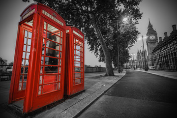 Fototapeta na wymiar Traditional red phone booth in London with the Big Ben in the background
