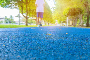 running track in runner rubber cover blue public park. for jogging exercise health lose weight concept copy space add text, select focus with shallow depth of field.