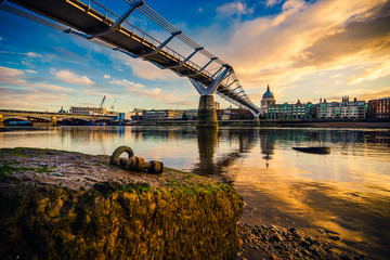 Millennium Bridge and St. Paul's cathedral at sunrise in London