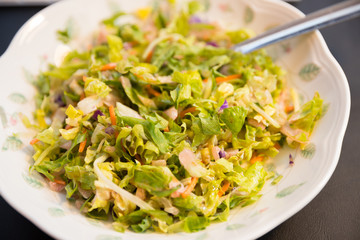 Fresh salad on the plate, close up.