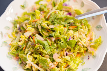 Fresh salad on the plate, close up.