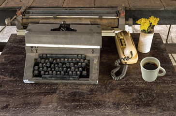 Vintage typewriter, old classic telephone and dry chrysanthemum flower on old wooden touch-up in still life concept