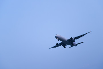 An aeroplane is flying in the evening.