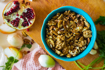 Walnuts in ceramic bowl good for salads, lunch or dinner meal and desserts. Raw vegan vegetarian healthy food.