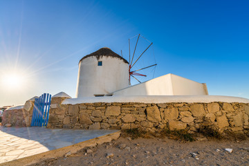 Traditional Greek windmill of Mykonos island with sun flare. Greece